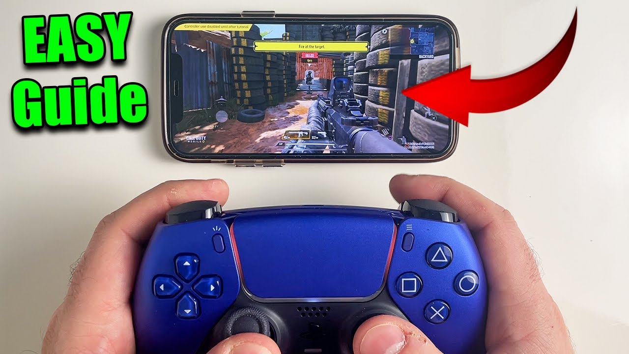 Player holding a PS5 DualSense controller paired with a mobile phone for COD Mobile